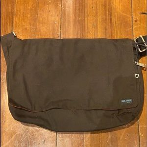 Jack Spade brown messenger bag with orange lining.